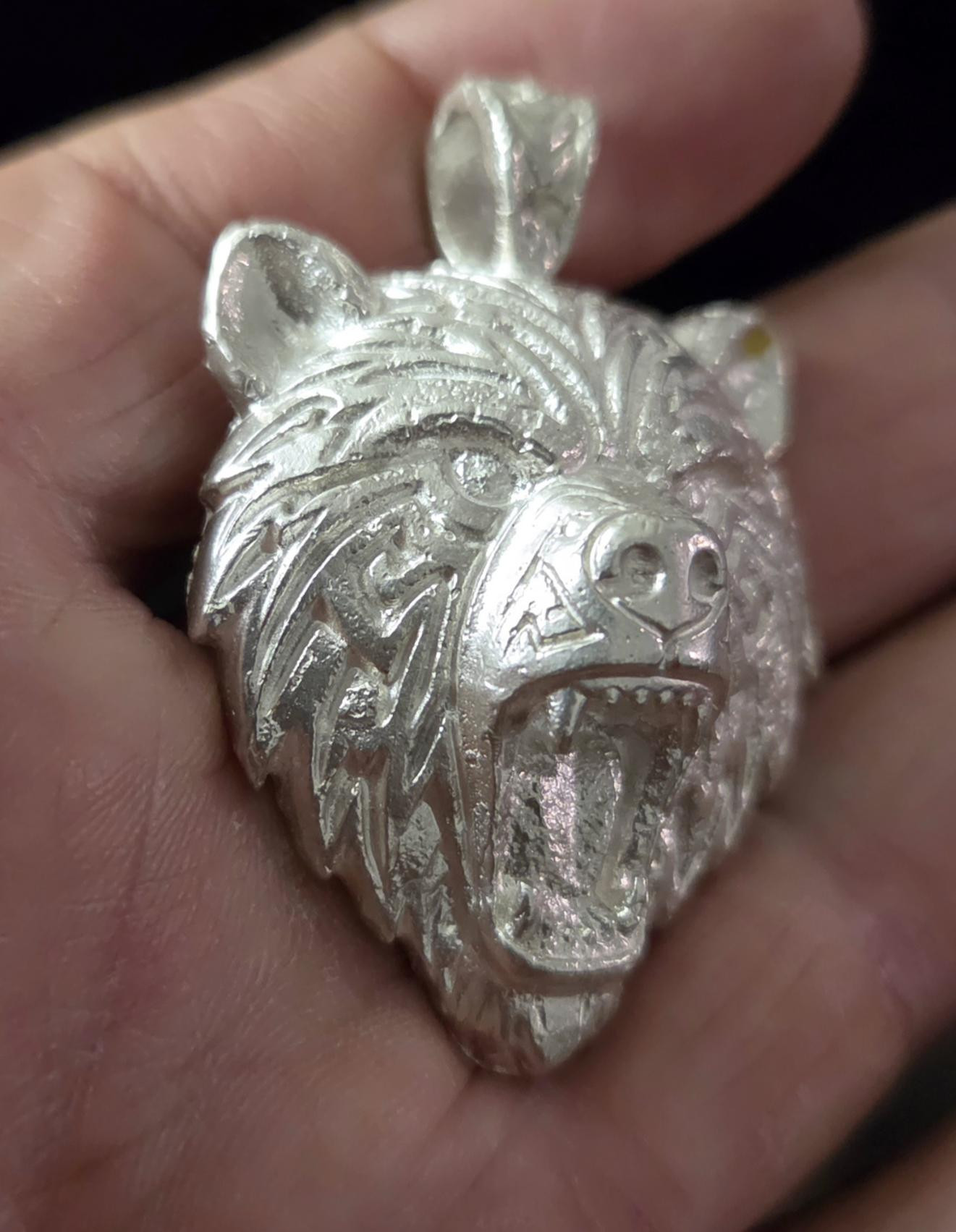Oso, a hand-cast silver bear pendant